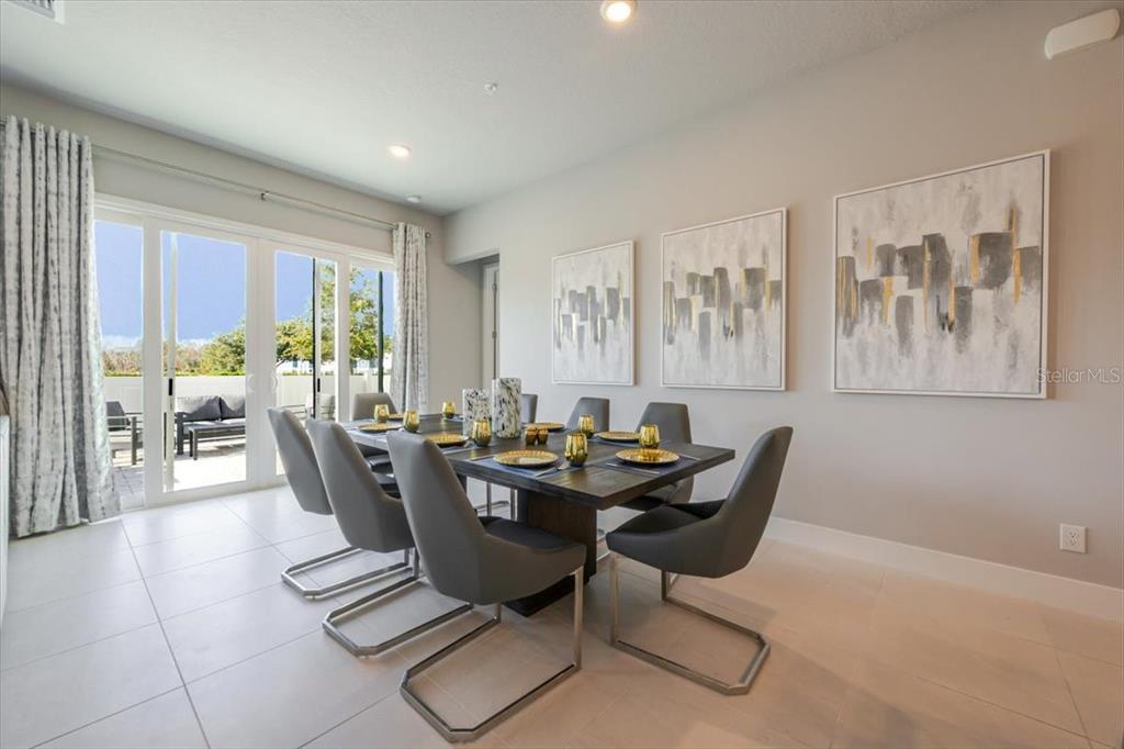 7770 Sandy Ridge Drive, Unit 144 Reunion, FL 34747 - Photo 10 of 22 a dining room with furniture a large window and a rug