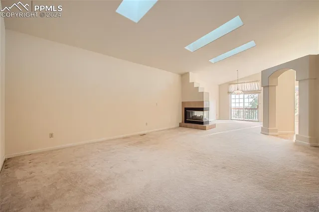 a view of an empty room with a fireplace