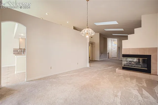 a view of an empty room and fire place