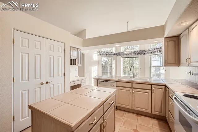 a kitchen that has a sink and a stove in it