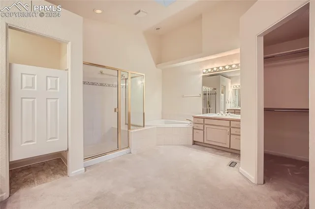 a bathroom with a tub sink and mirror