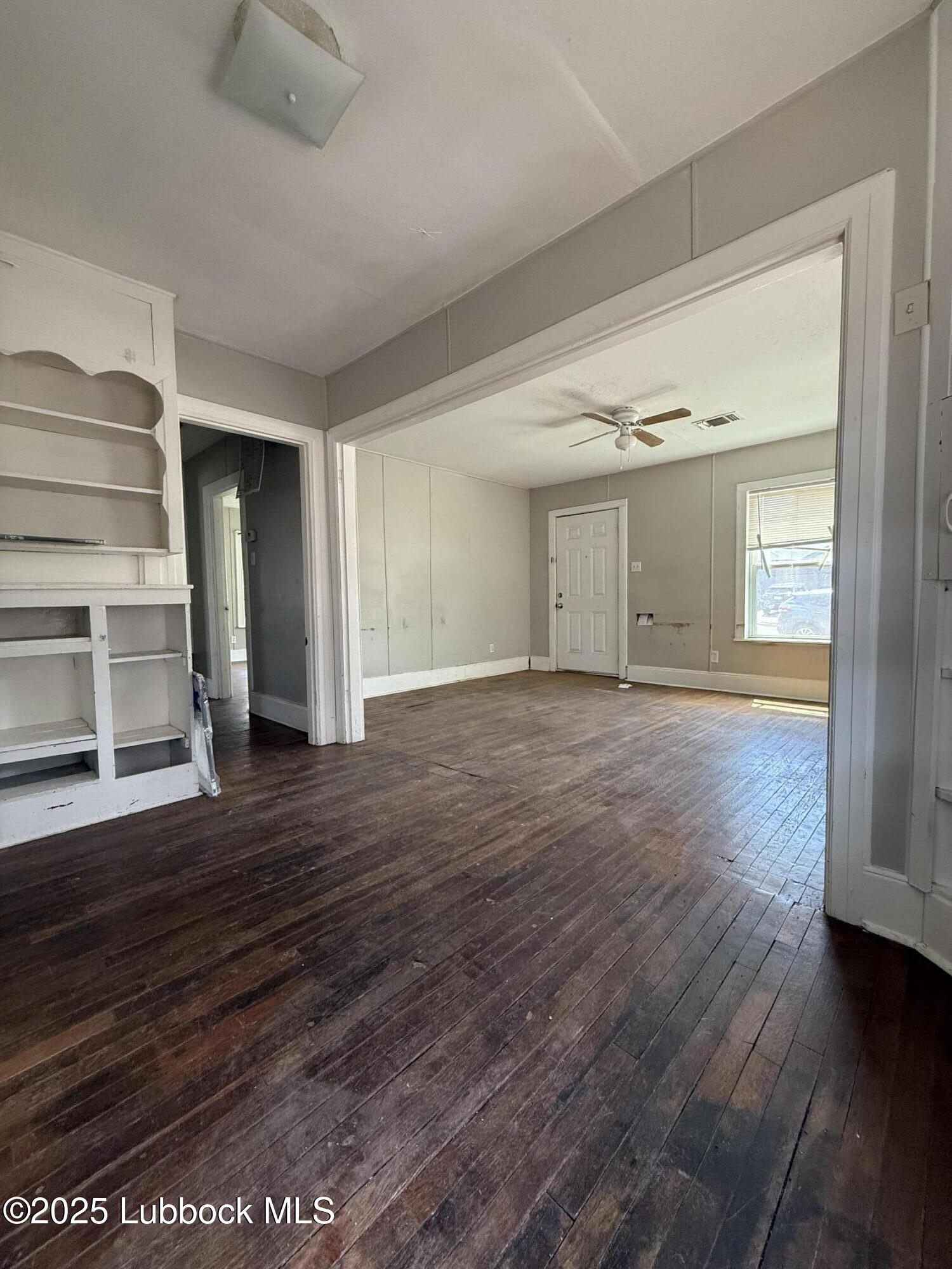 2116 20th Street Lubbock, TX 79411 - Photo 2 of 7 wooden floor in an empty room with a window