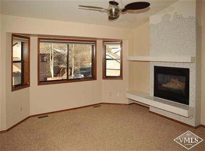 22 Spruce Circle Edwards, CO 81632 - Photo 2 of 7 an empty room with windows and fireplace