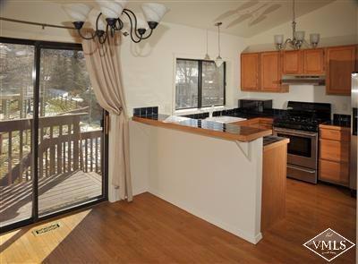 22 Spruce Circle Edwards, CO 81632 - Photo 4 of 7 a kitchen with stainless steel appliances granite countertop a stove a sink and a refrigerator