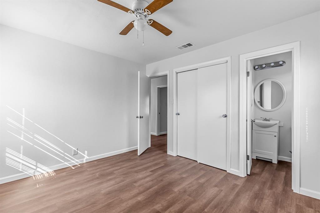 2117 Frazier Street Greenville, TX 75401 - Photo 15 of 25 wooden floor in an empty room with a window