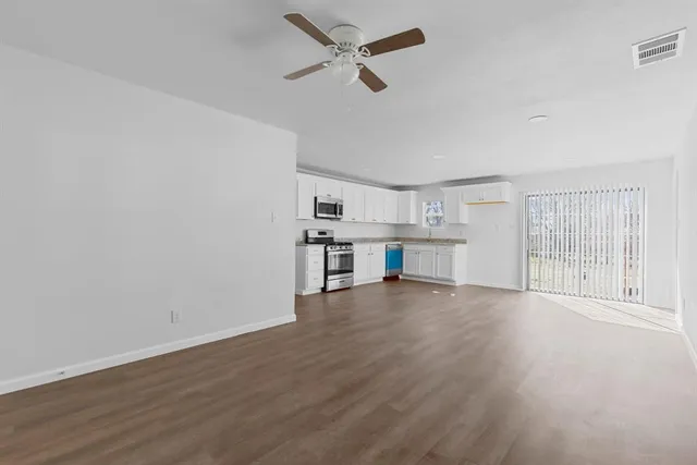 wooden floor in an empty room with a window
