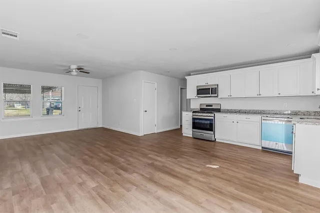 a view of a kitchen with microwave and cabinets
