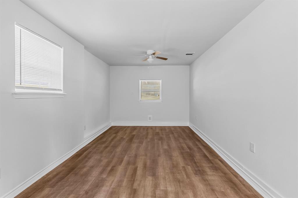 2117 Frazier Street Greenville, TX 75401 - Photo 8 of 25 an empty room with a window