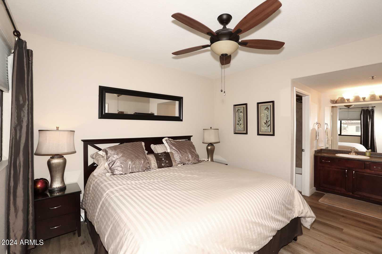 4925 East Desert Cove Avenue, Unit 363 Scottsdale, AZ 85254 - Photo 12 of 47 a bedroom with a bed and a chandelier