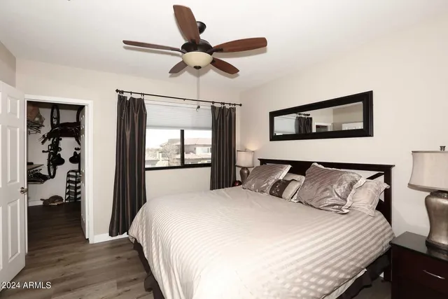 a bedroom with a large bed and a chandelier
