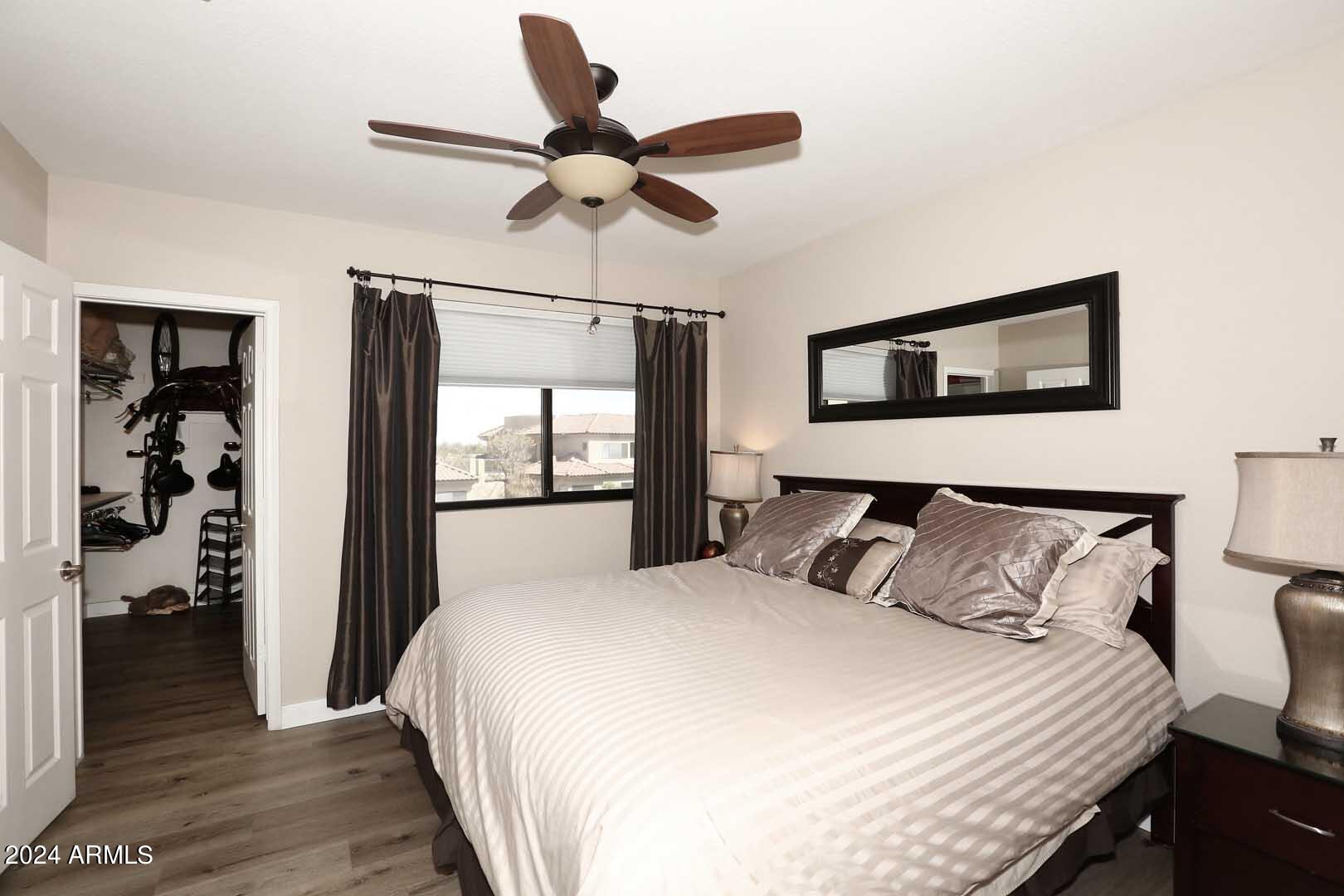 4925 East Desert Cove Avenue, Unit 363 Scottsdale, AZ 85254 - Photo 13 of 47 a bedroom with a large bed and a chandelier