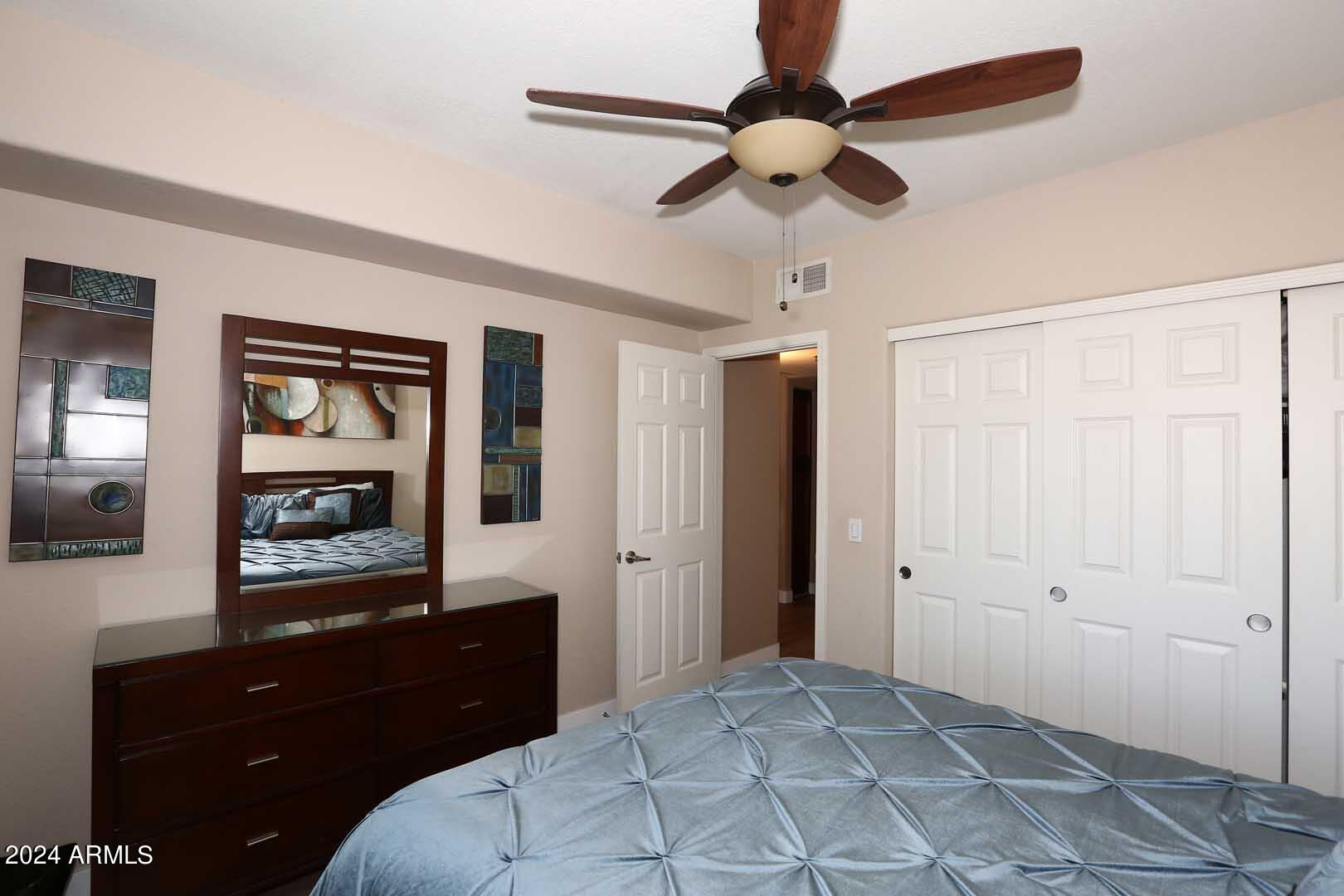 4925 East Desert Cove Avenue, Unit 363 Scottsdale, AZ 85254 - Photo 18 of 47 a bedroom with a bed and a mirror on dresser