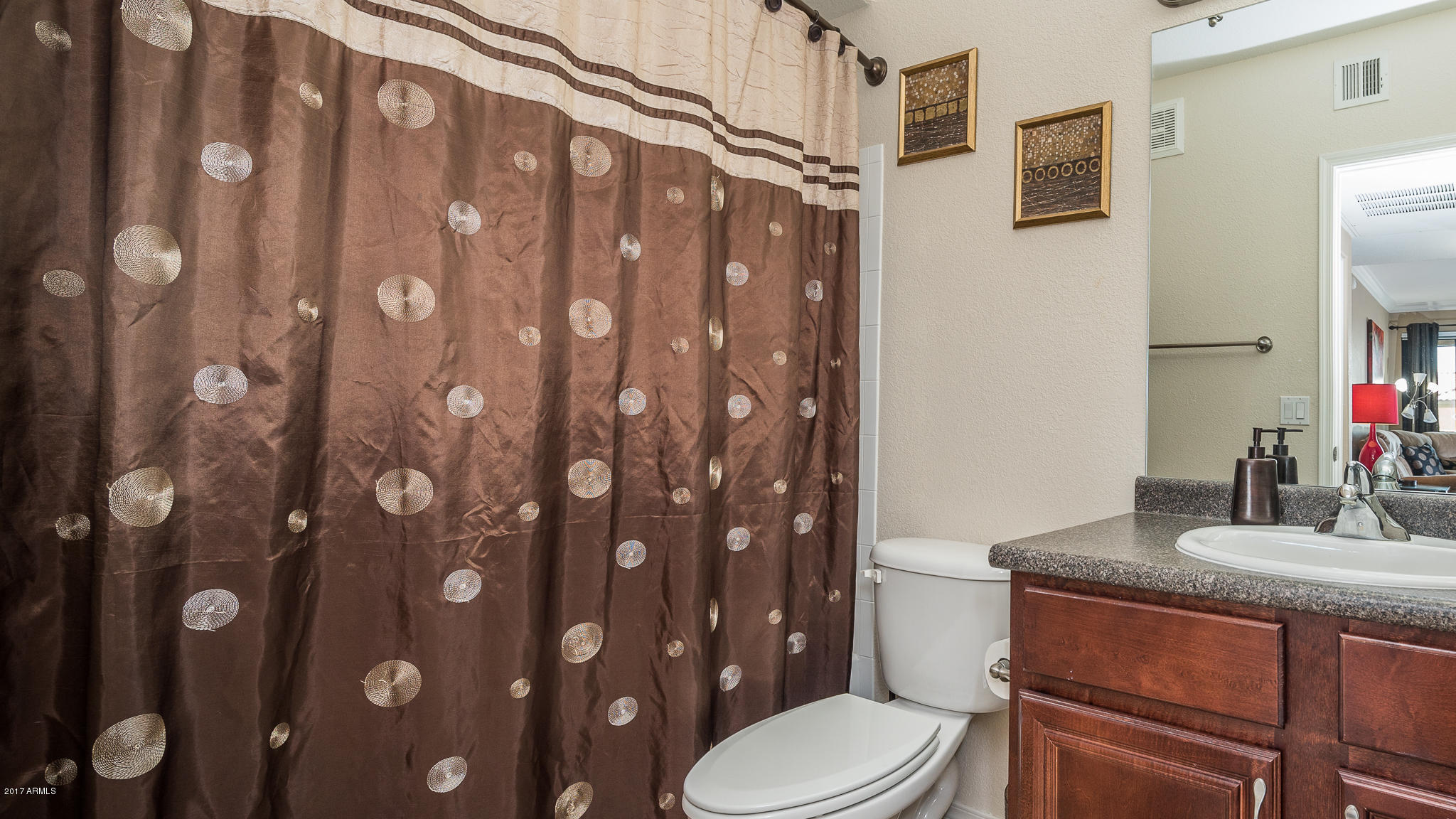 4925 East Desert Cove Avenue, Unit 363 Scottsdale, AZ 85254 - Photo 20 of 47 a bathroom with a granite countertop toilet sink and shower curtain
