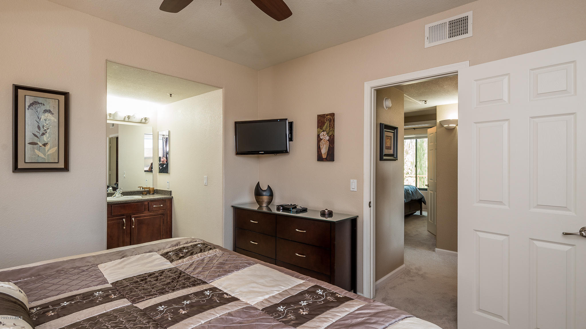 4925 East Desert Cove Avenue, Unit 363 Scottsdale, AZ 85254 - Photo 27 of 47 a bedroom with a bed and a dresser in it
