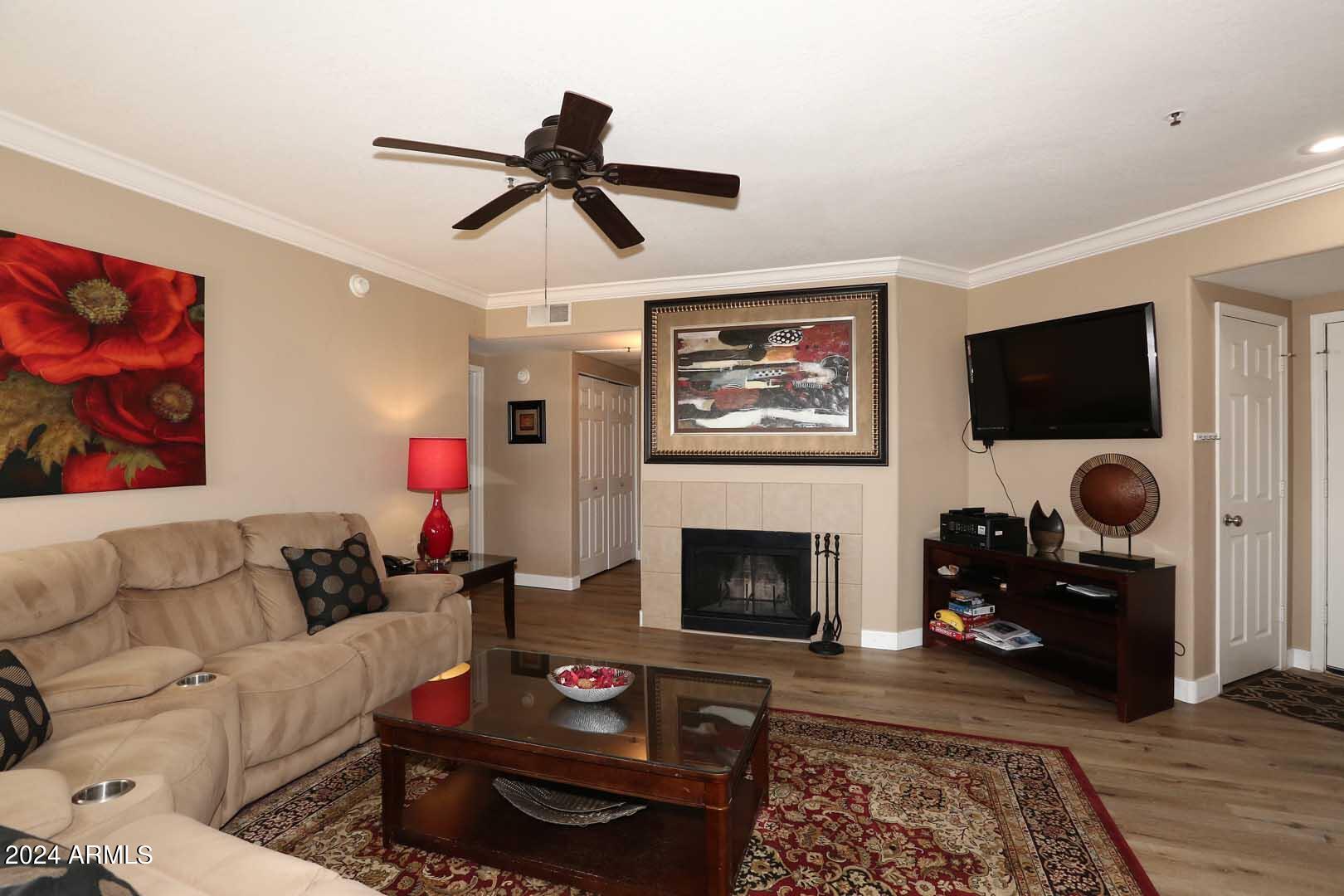 4925 East Desert Cove Avenue, Unit 363 Scottsdale, AZ 85254 - Photo 3 of 47 a living room with furniture and a fireplace