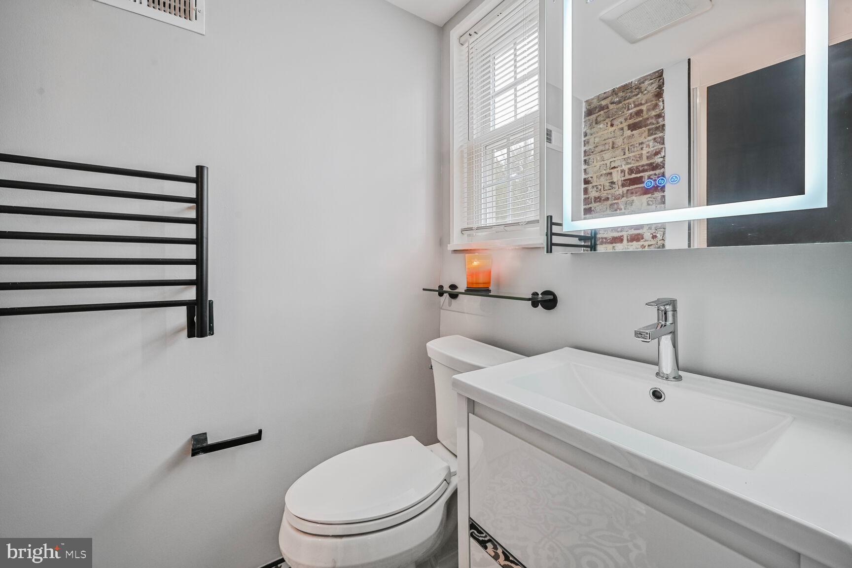 1323 Fernway Road Northwest Washington, DC 20012 - Photo 16 of 24 a white toilet sitting next to a bathroom sink