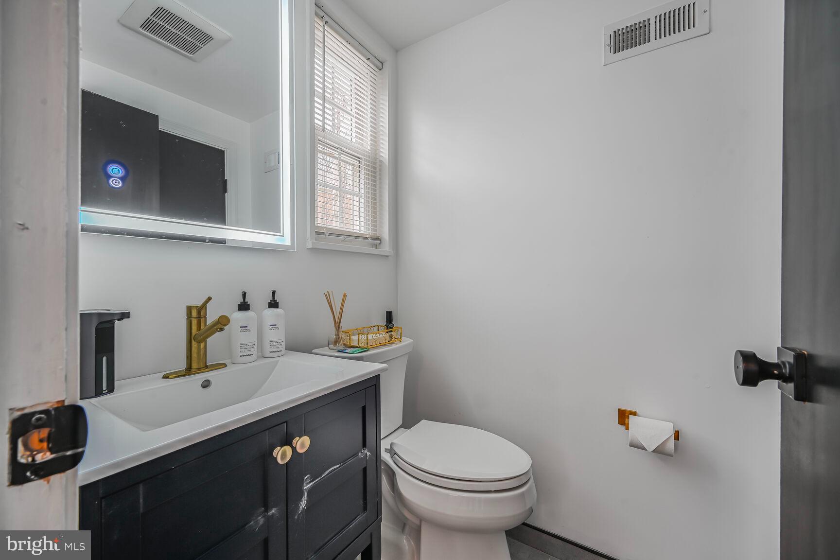1323 Fernway Road Northwest Washington, DC 20012 - Photo 10 of 24 a bathroom with a sink toilet and mirror