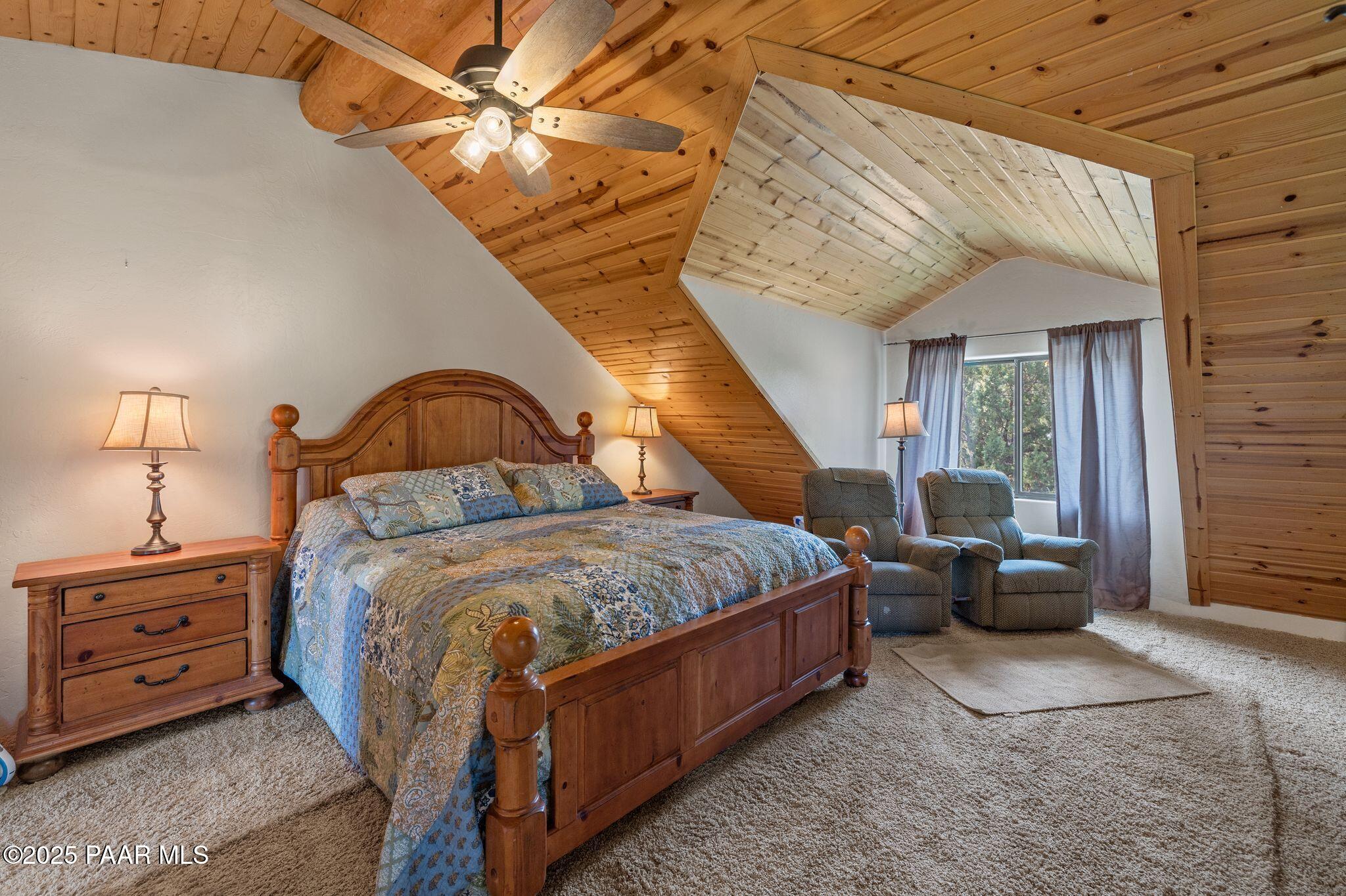 4575 East Combination Lane Prescott, AZ 86303 - Photo 29 of 50 a spacious bedroom with a bed and a chandelier