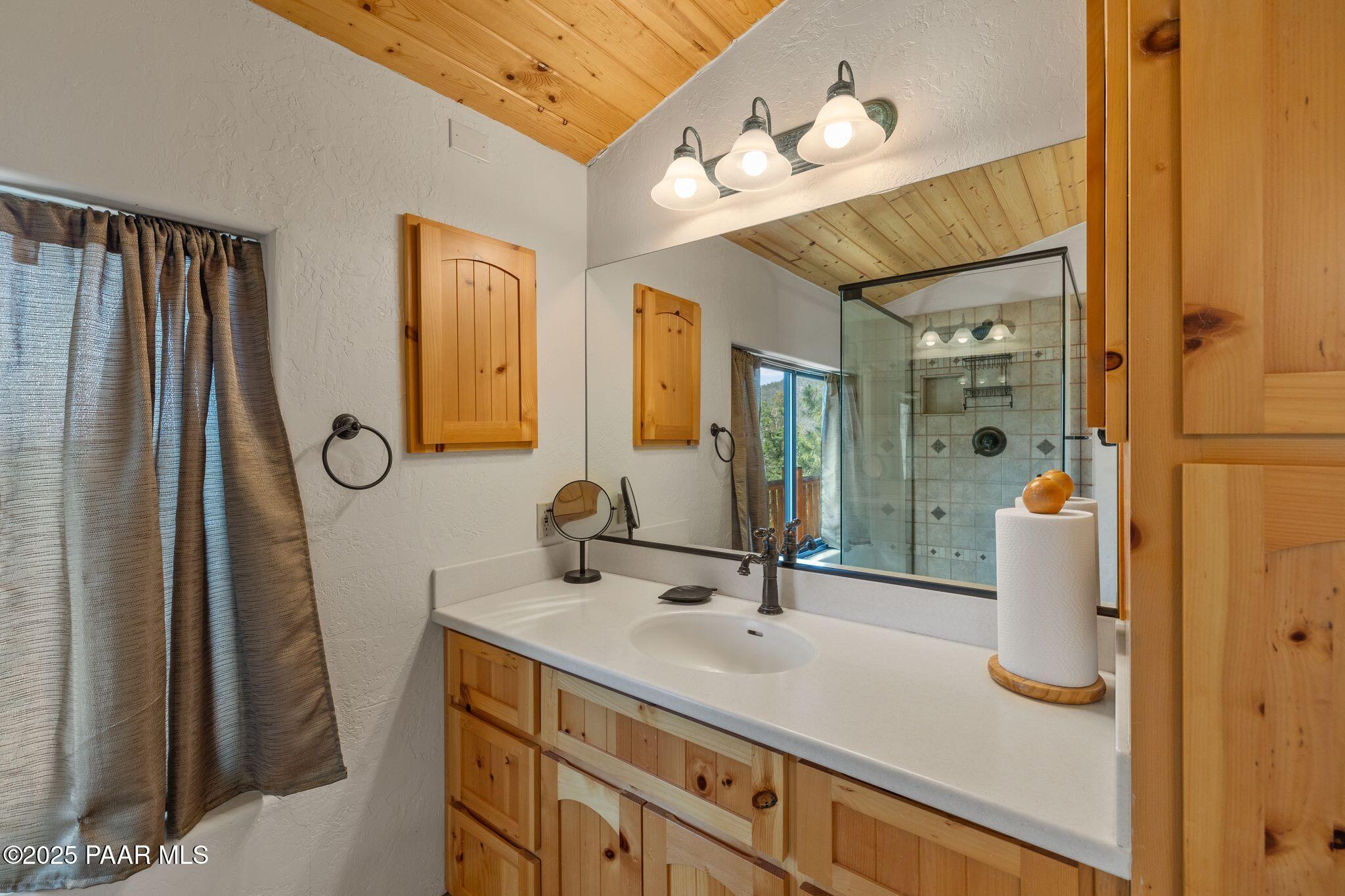 4575 East Combination Lane Prescott, AZ 86303 - Photo 32 of 50 a bathroom with a sink vanity granite and a mirror