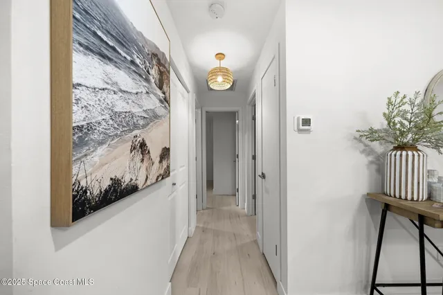 a view of a hallway and wooden floor