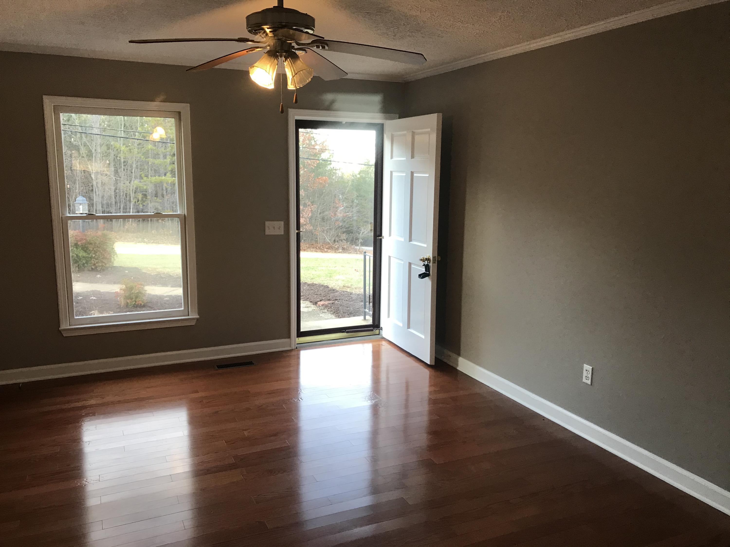 5536 Blue Ridge Drive Hurt, VA 24563 - Photo 11 of 14 an empty room with wooden floor and windows