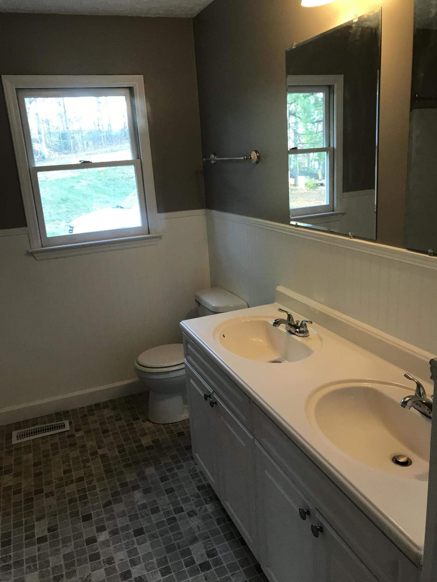 5536 Blue Ridge Drive Hurt, VA 24563 - Photo 6 of 14 a bathroom with a granite countertop sink toilet and mirror