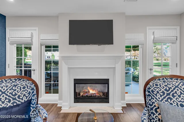 a living room with a fireplace and a flat screen tv