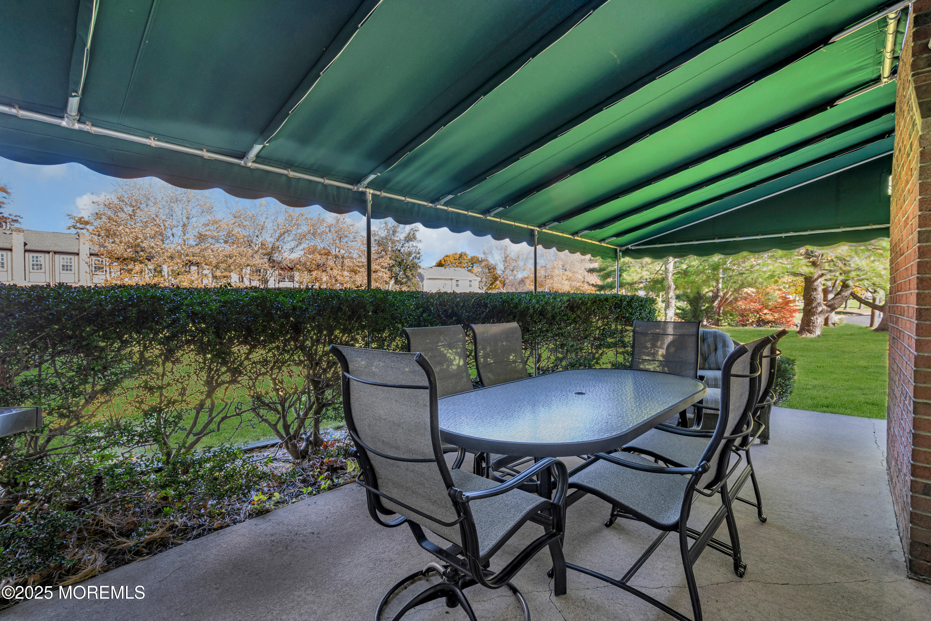 68 Maple Drive Spring Lake Heights, NJ 07762 - Photo 20 of 24 a view of patio with table and chairs under an umbrella with a small yard