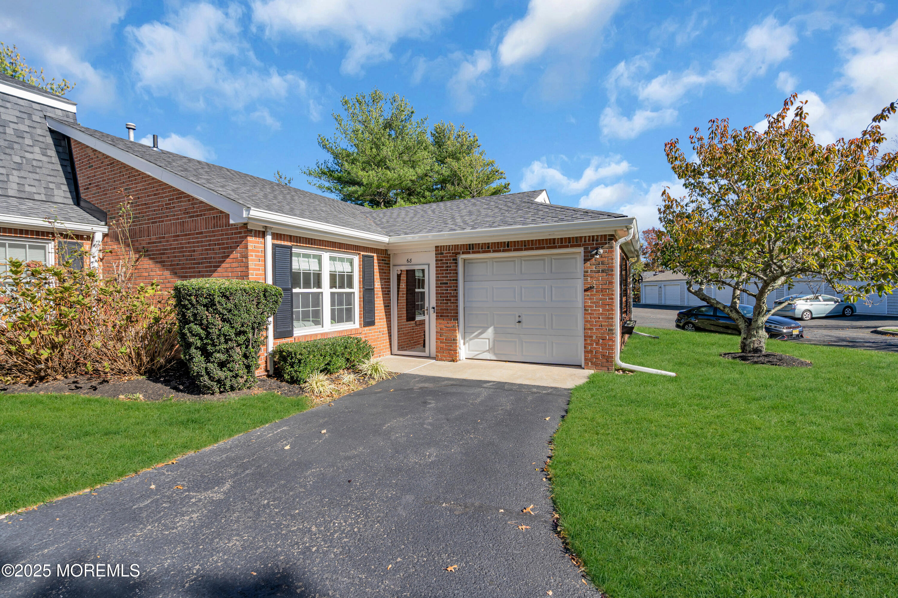 68 Maple Drive Spring Lake Heights, NJ 07762 - Photo 2 of 24 a front view of a house with a yard and garage