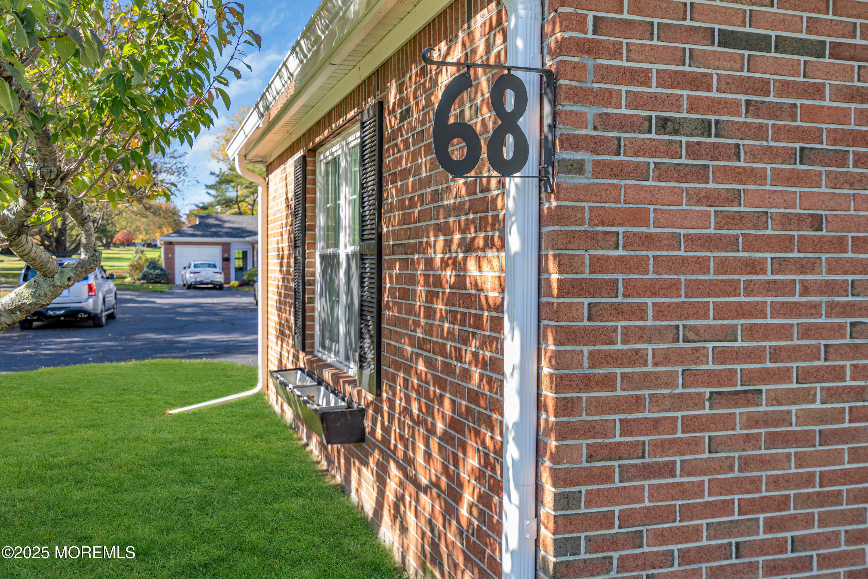 68 Maple Drive Spring Lake Heights, NJ 07762 - Photo 3 of 24 a brick building with a sign on it
