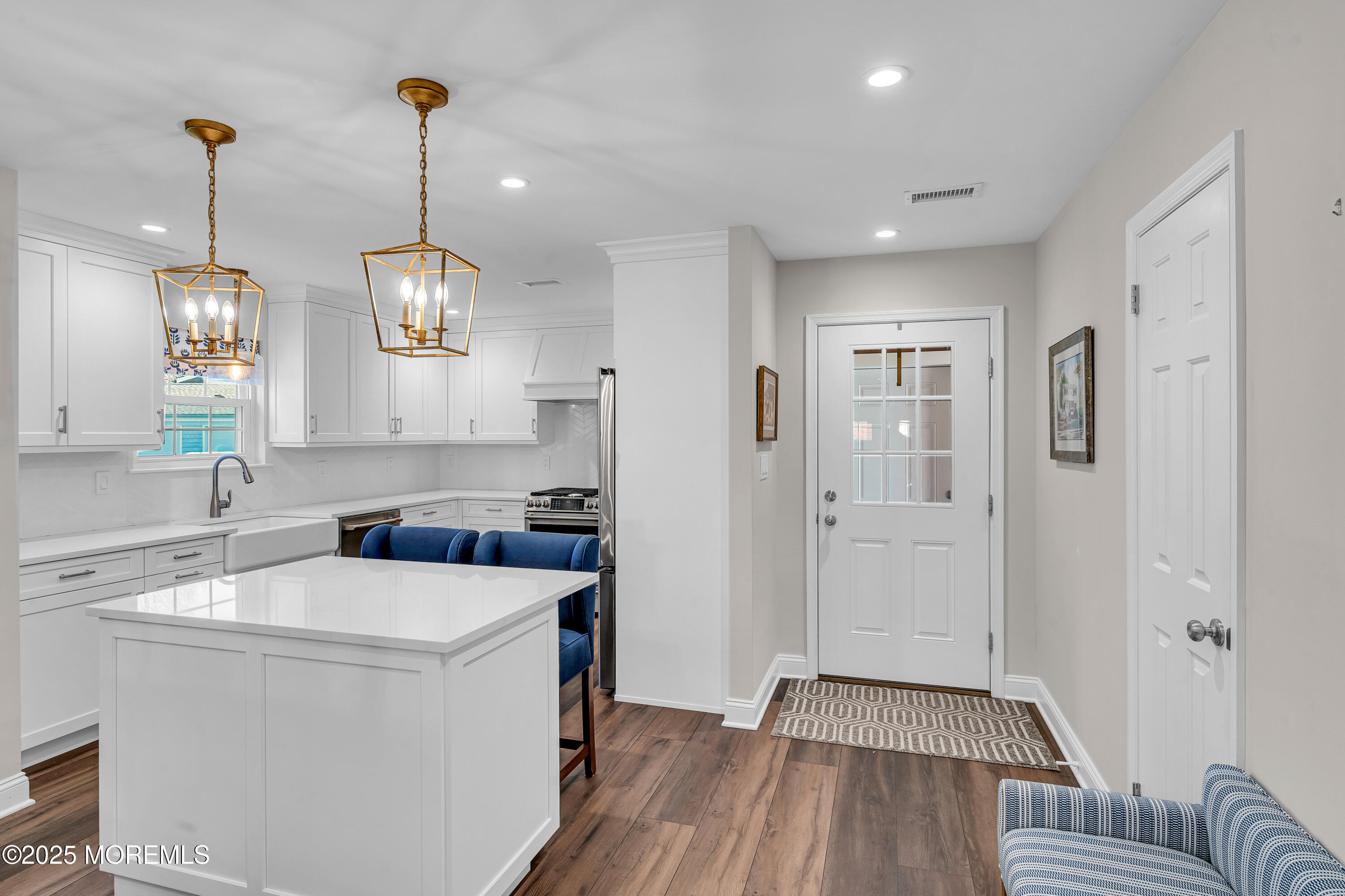 68 Maple Drive Spring Lake Heights, NJ 07762 - Photo 5 of 24 a kitchen that has a sink stainless steel appliances cabinets and a wooden floor