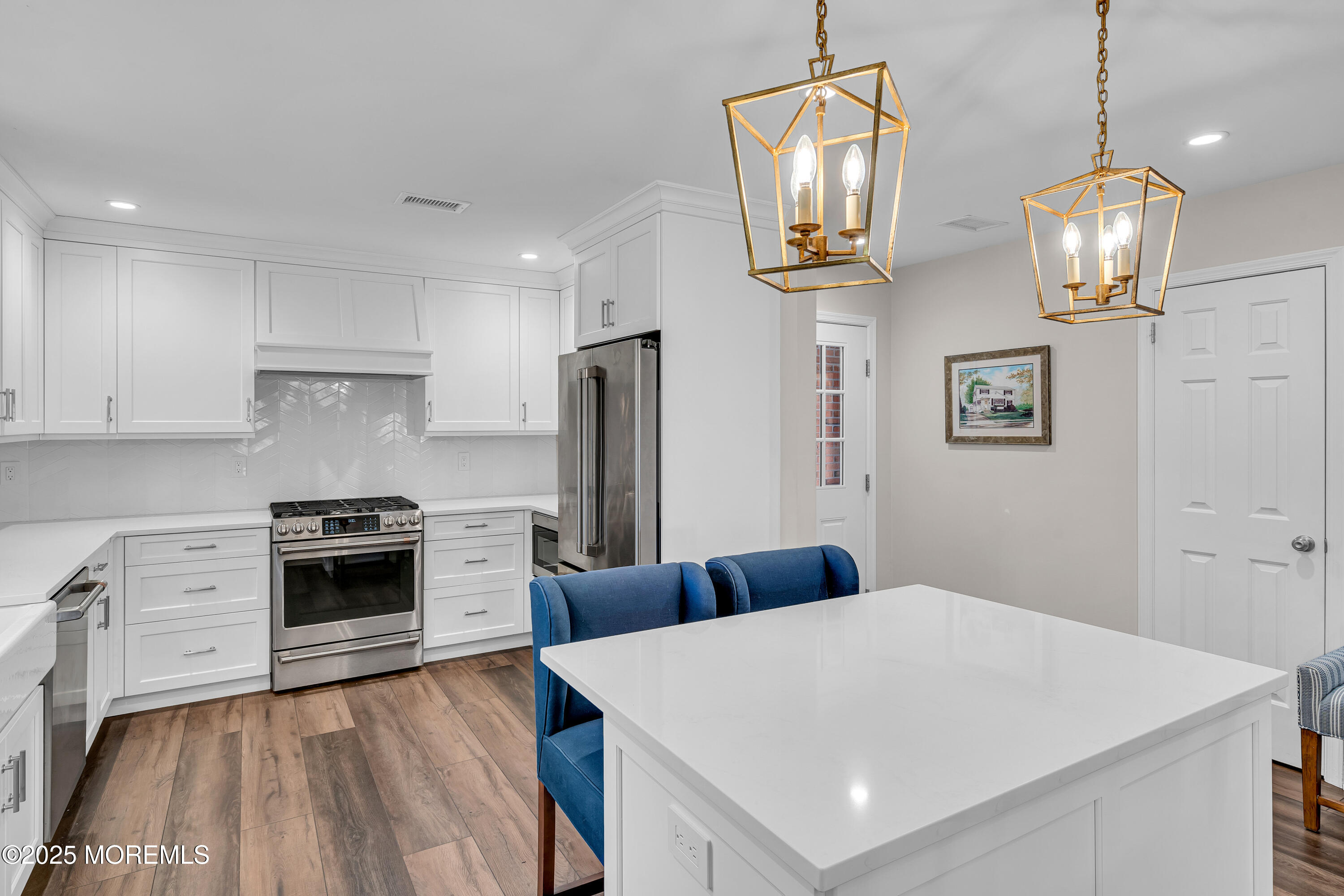 68 Maple Drive Spring Lake Heights, NJ 07762 - Photo 7 of 24 a kitchen with stainless steel appliances a stove refrigerator and wooden floor