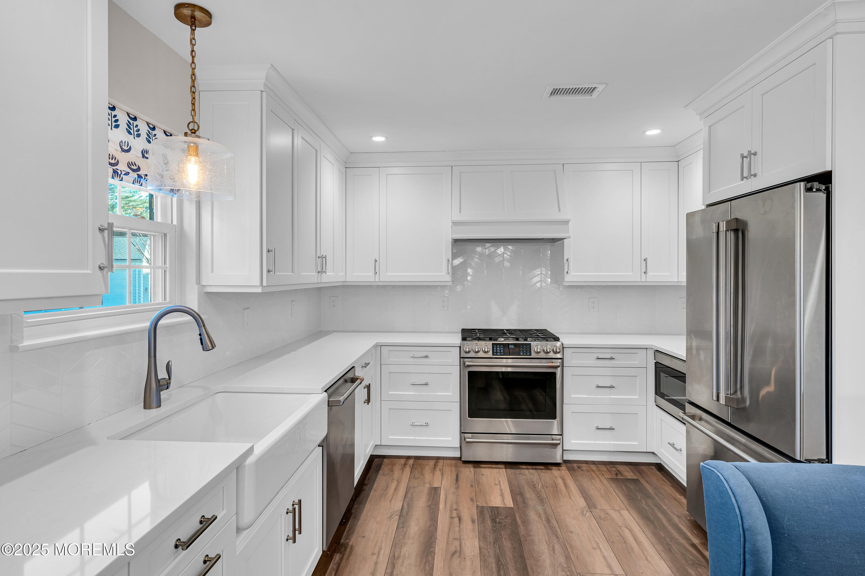 68 Maple Drive Spring Lake Heights, NJ 07762 - Photo 8 of 24 a kitchen with stainless steel appliances a stove a sink a refrigerator and a wooden floor