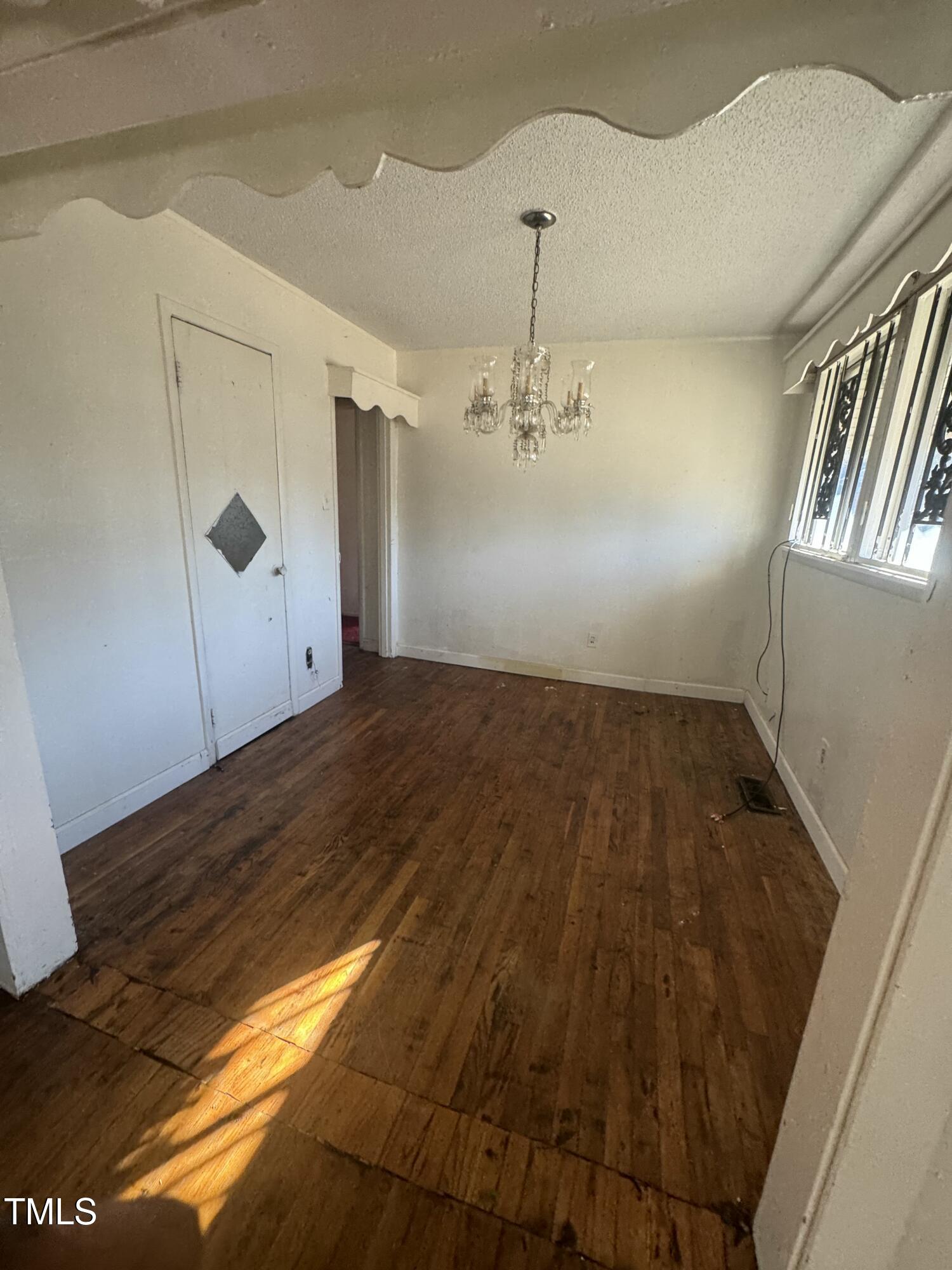 1100 Hadley Road Raleigh, NC 27610 - Photo 3 of 3 a view of empty room with wooden floor