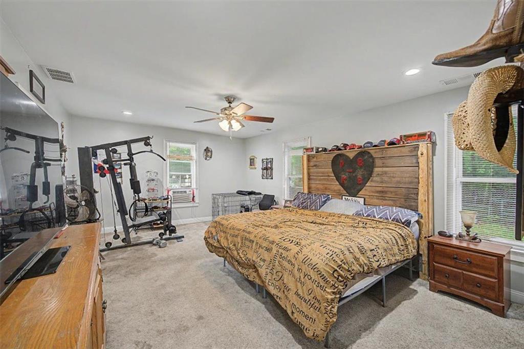483 Coal Road Northwest Resaca, GA 30735 - Photo 28 of 56 a bedroom with a bed and a chandelier