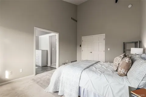 a bedroom with a bed and a lamp