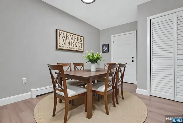 a view of a dining room with furniture and wooden floor