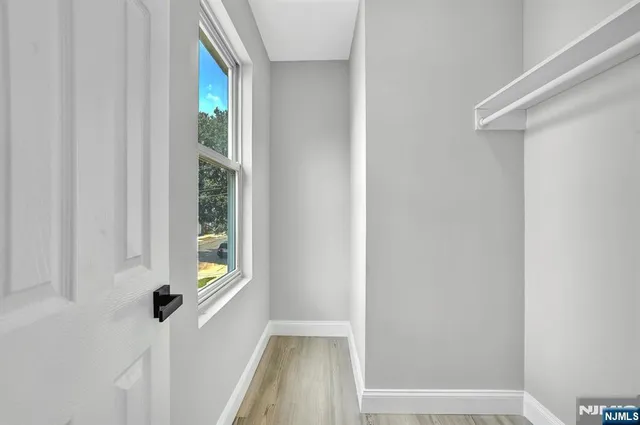 a view of a hallway with a window