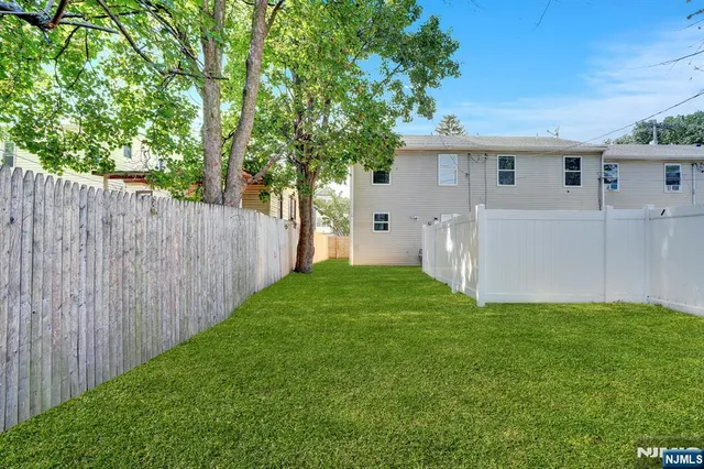 a view of a backyard with a large tree
