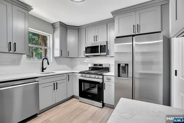 a kitchen with a refrigerator and a sink