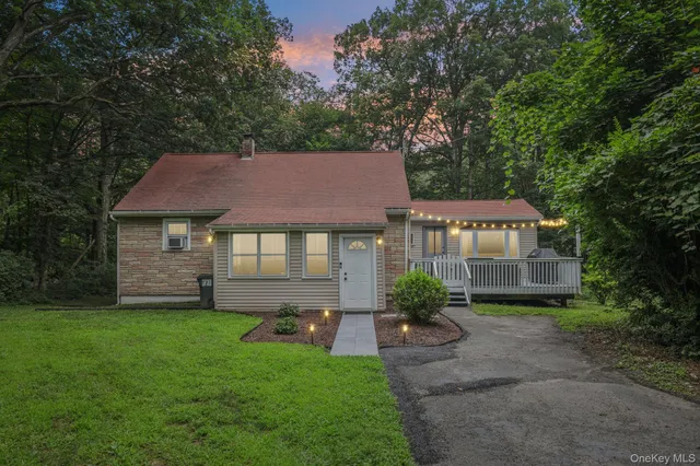 a aerial view of a house next to a big yard and large trees