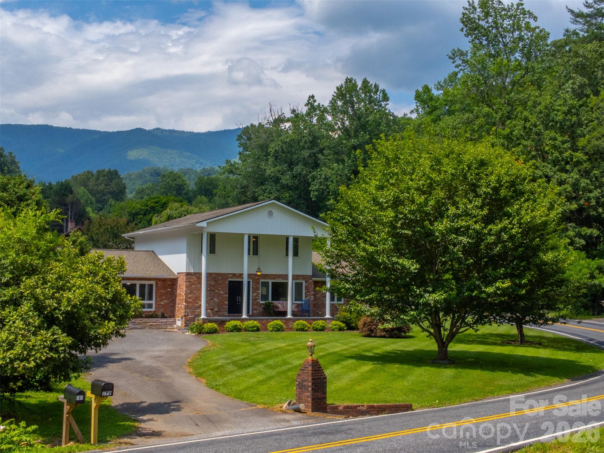 a front view of a house with a garden