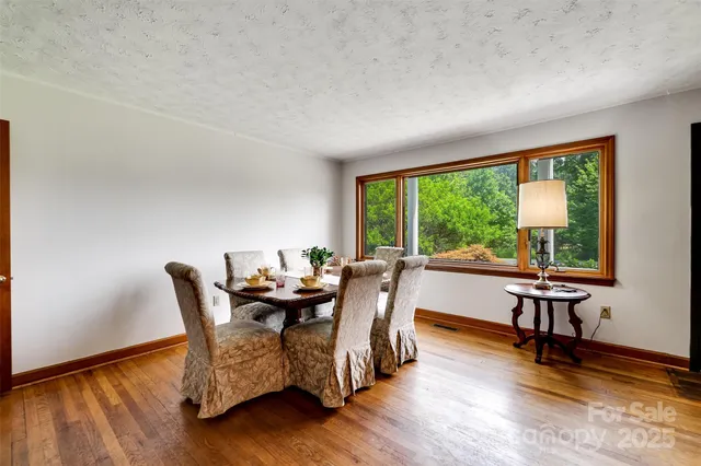 a dining room with furniture and wooden floor