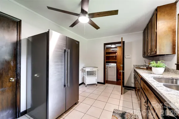 a kitchen with a refrigerator and a sink