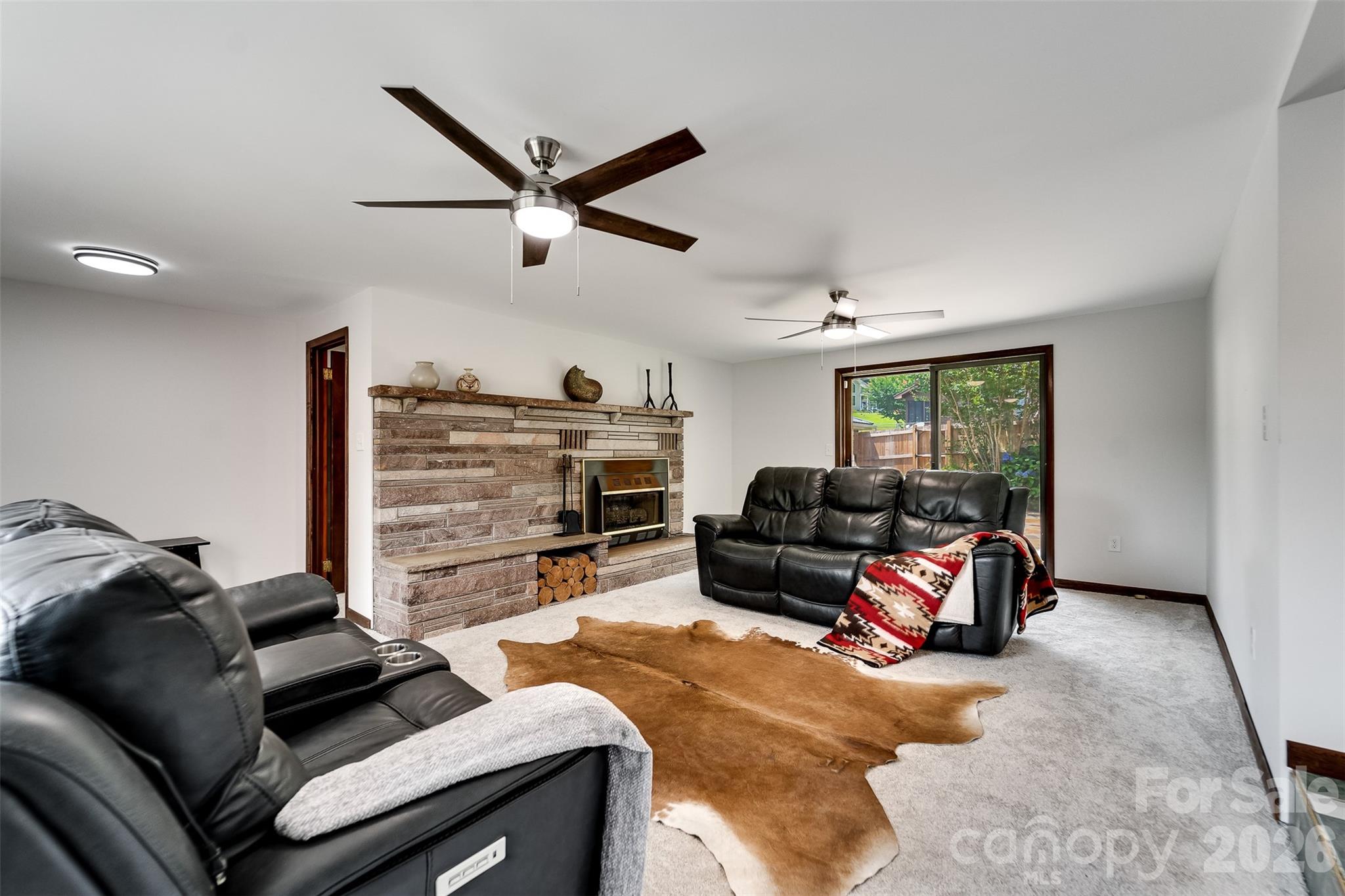 181 Fisher Crk Road Sylva, NC 28779 - Photo 15 of 48 a living room with furniture and a flat screen tv