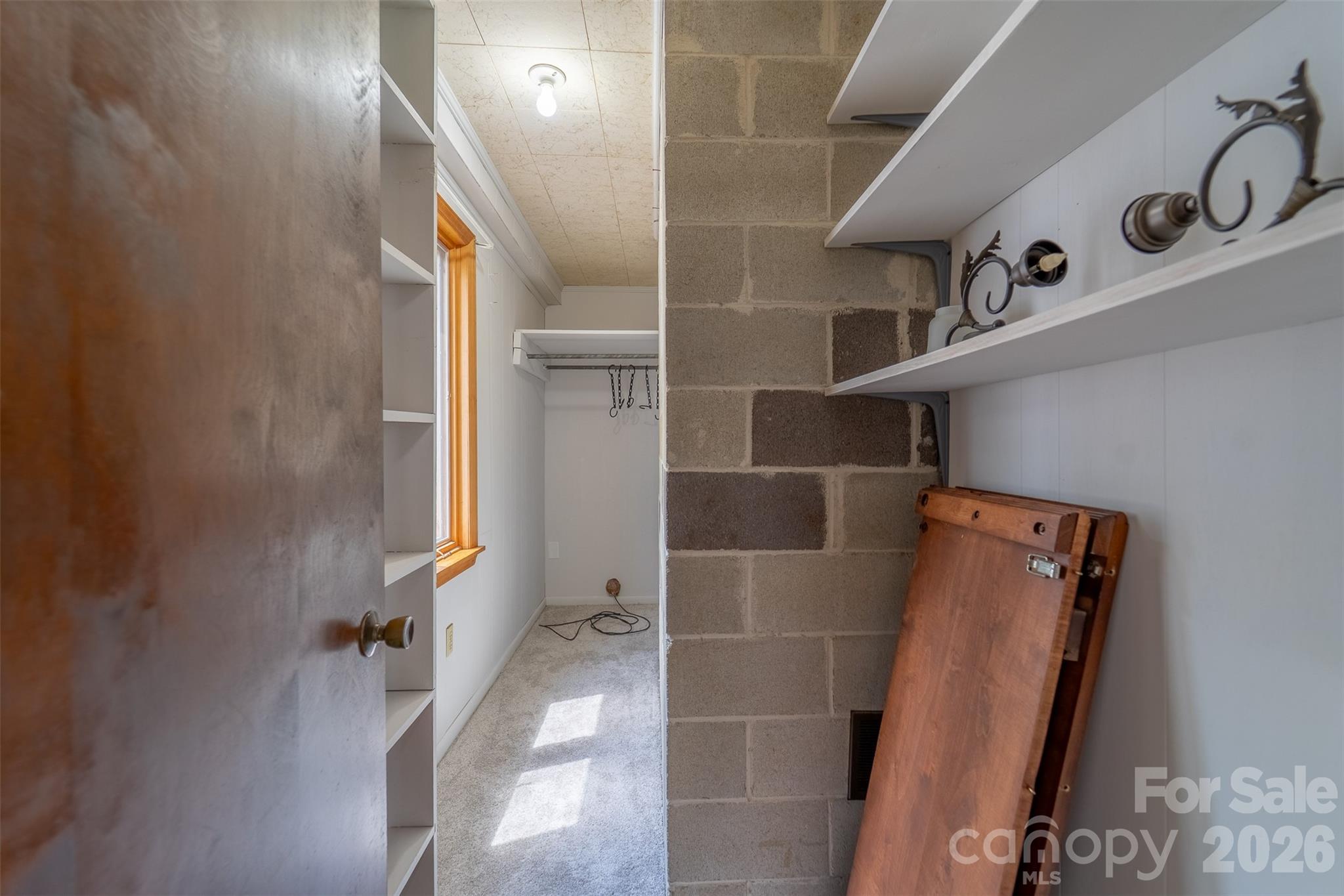 181 Fisher Crk Road Sylva, NC 28779 - Photo 19 of 48 a view of walk in closet with clothes and shoes