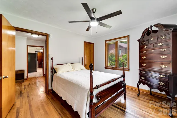 a bed sitting in a bedroom next to a window