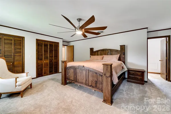 a bedroom with a bed and a large window