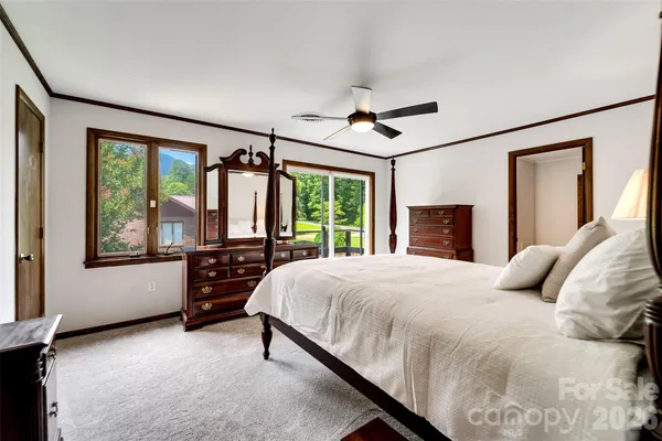 a bedroom with a large bed and a large window