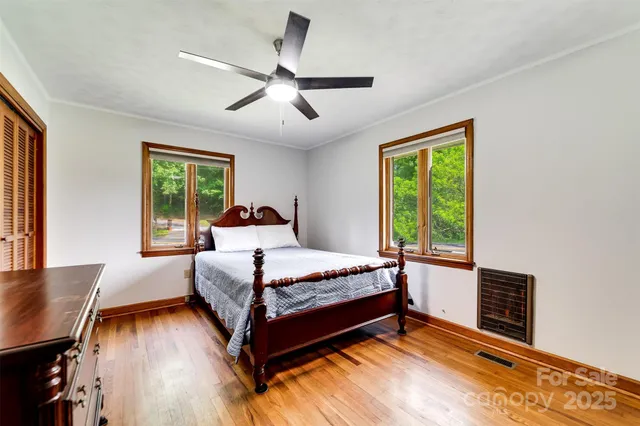 a bedroom with a bed and wooden floor